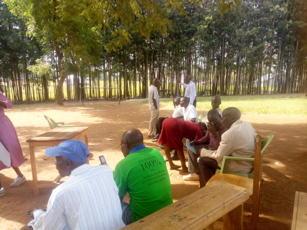 Community members meeting outdoors in the Nyanza Gulf region